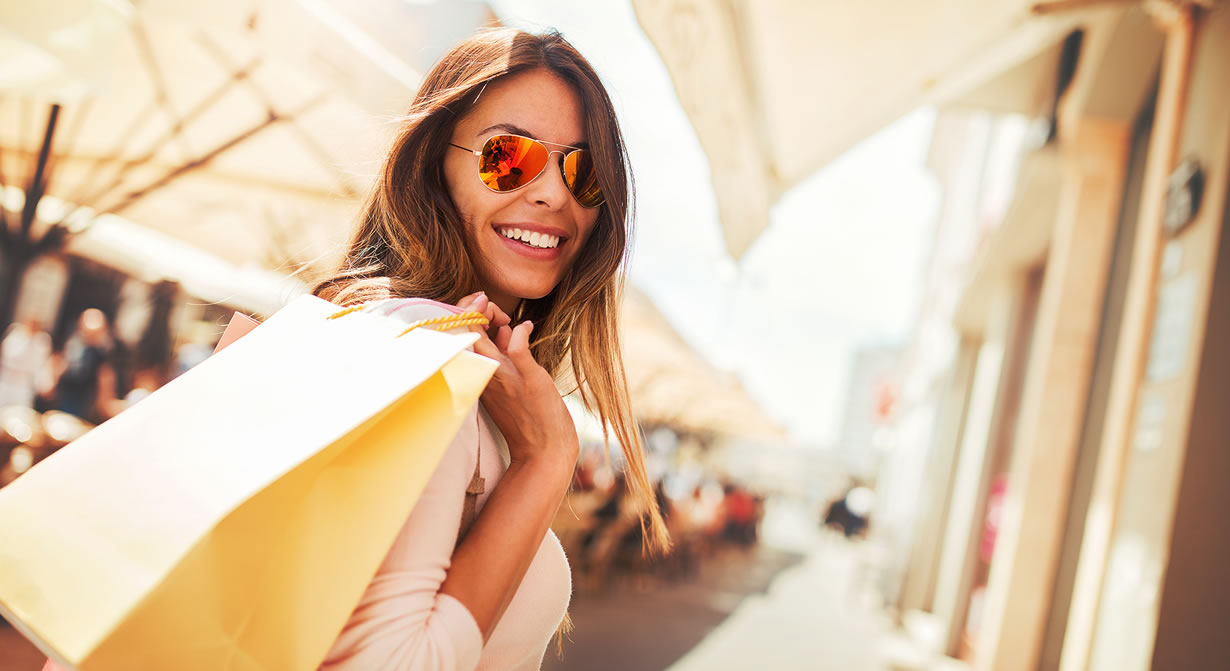 woman in sunglasses with shopping bag